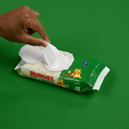 Baby boy playing with Huggies® wipes, the #1 branded baby wipe